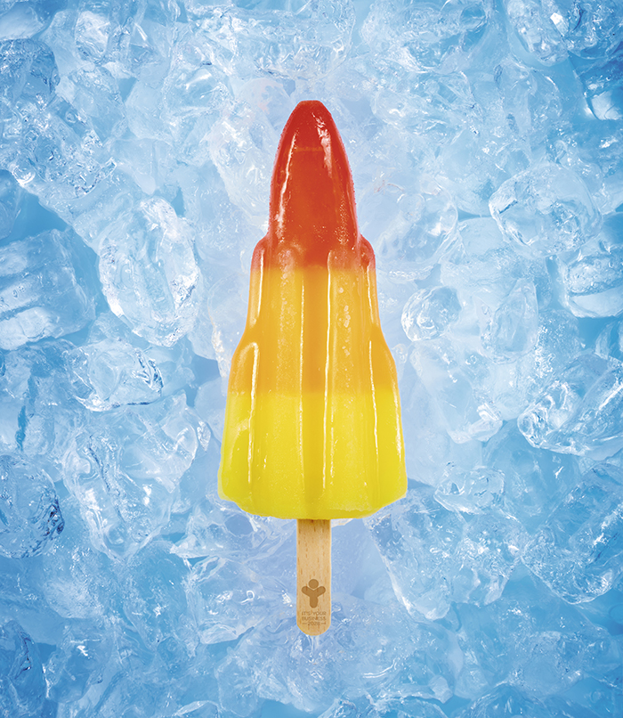 A photograph of a rocket ice pop resting on ice