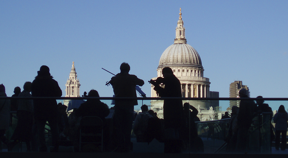 Silhouettes of buskers on the South Bank, London